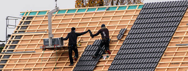 Professional roofers doing roof replacements