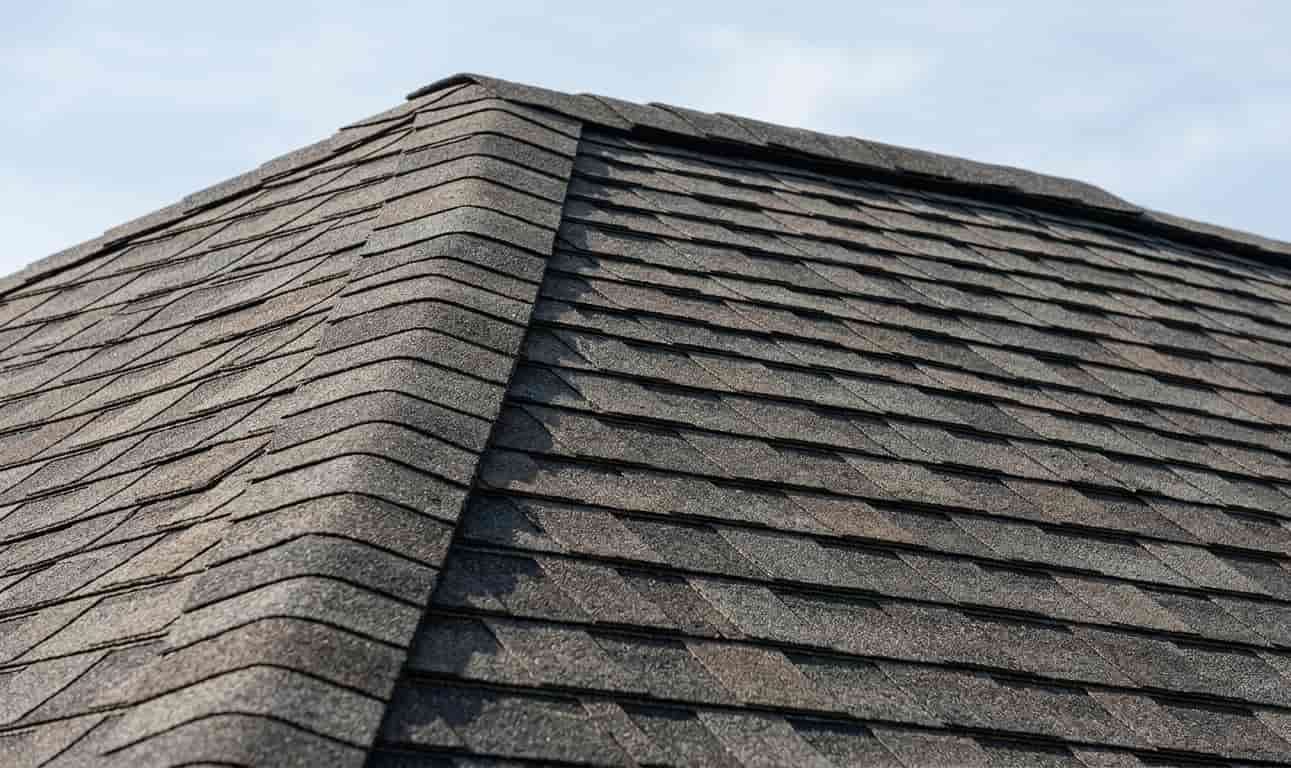a roof hip and ridge capped with dark brown architectural shingles