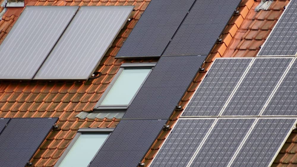 Close-up view of solar shingles on a tiled roof showcasing energy efficient roofing options