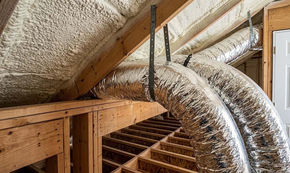 Interior view of an attic featuring spray foam insulation