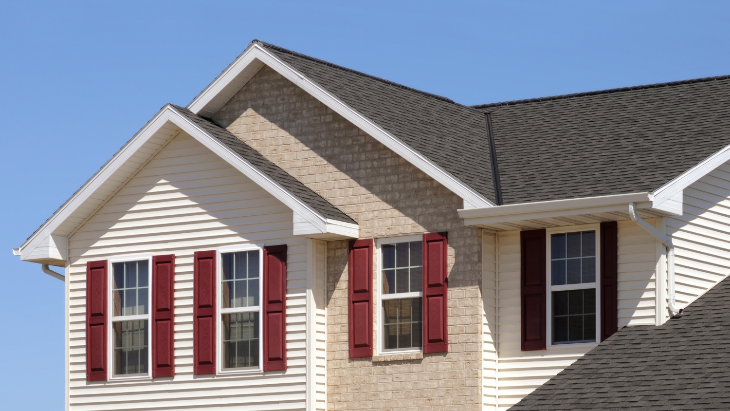 multiple dark-shingled gable rooflines