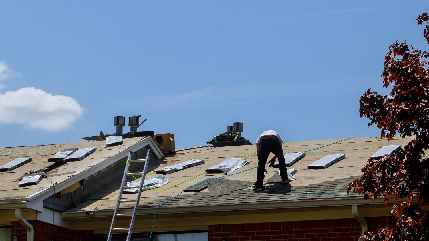 a roofer working on a residential rooftop
