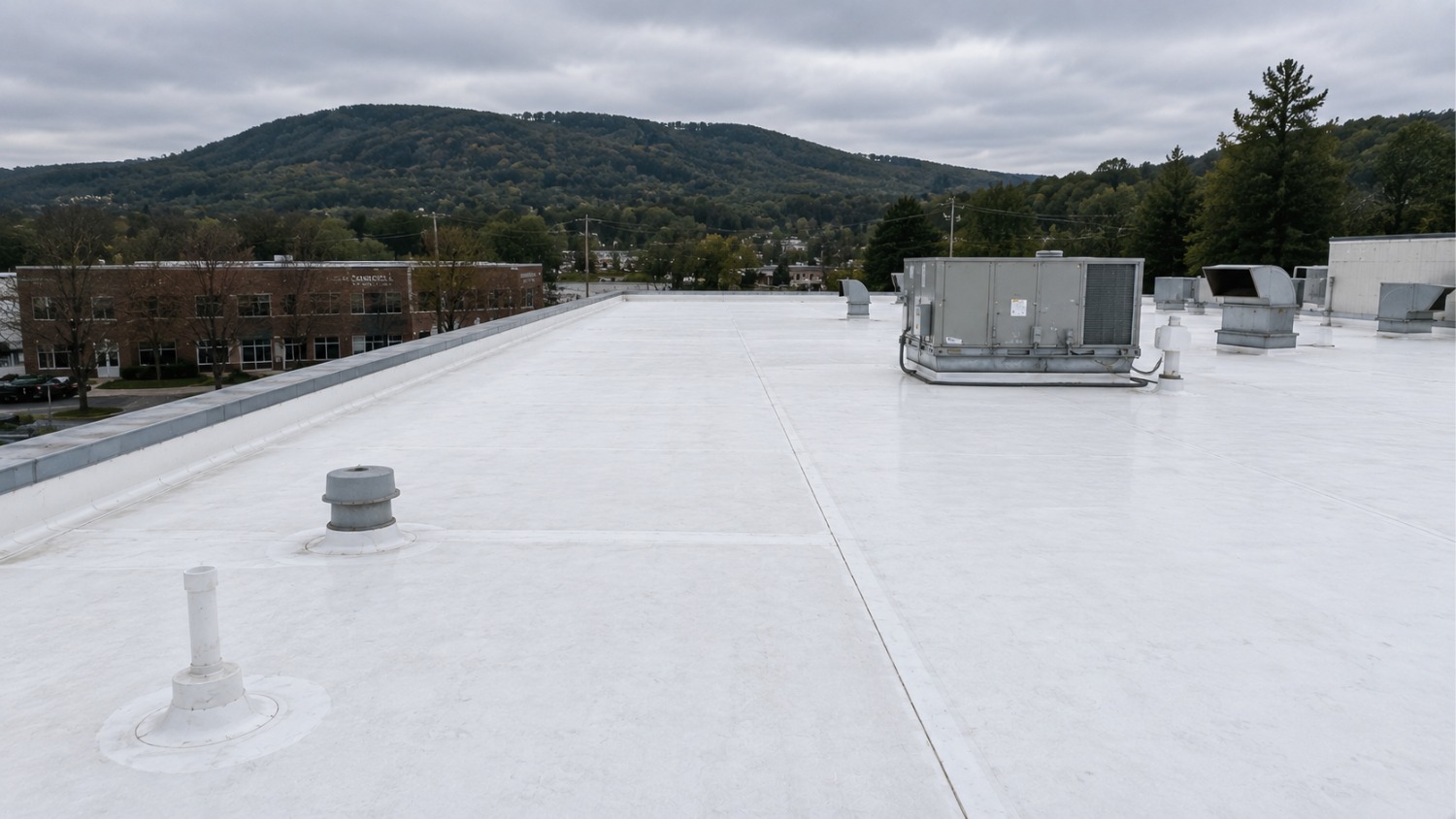 clean white TPO commercial roof with HVAC units