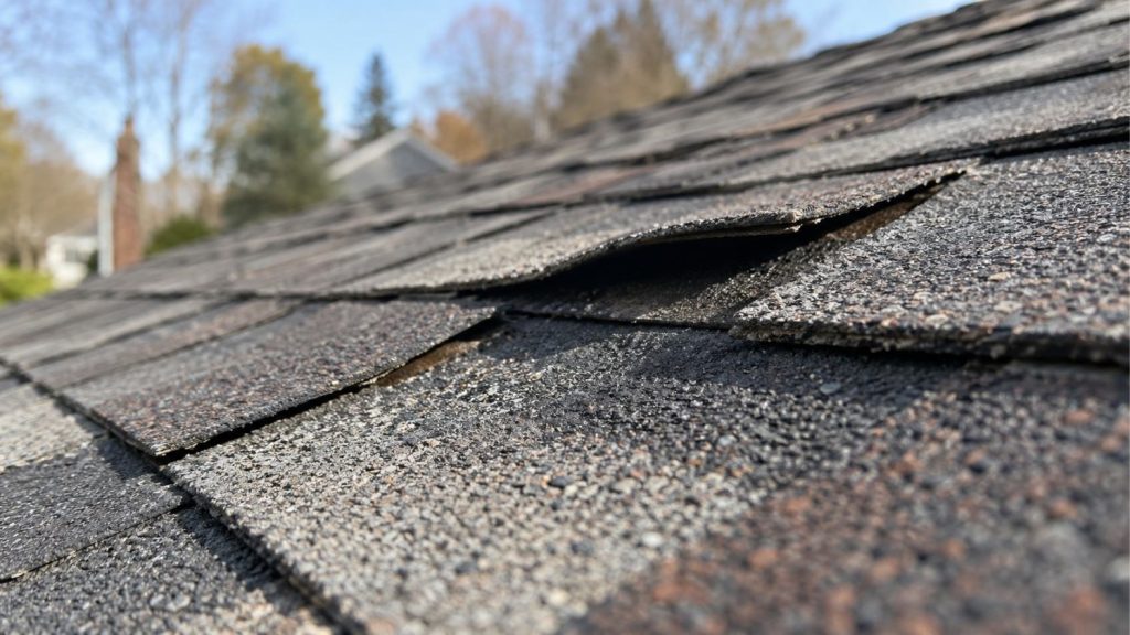 architectural asphalt shingles that have been visibly lifted