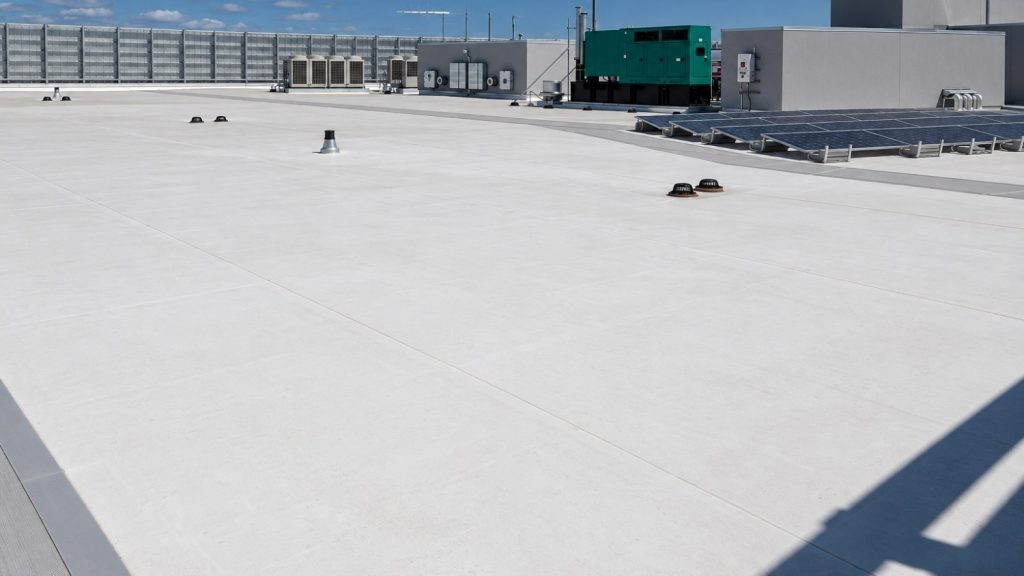 wide commercial flat roof covered in a bright white TPO roofing membrane