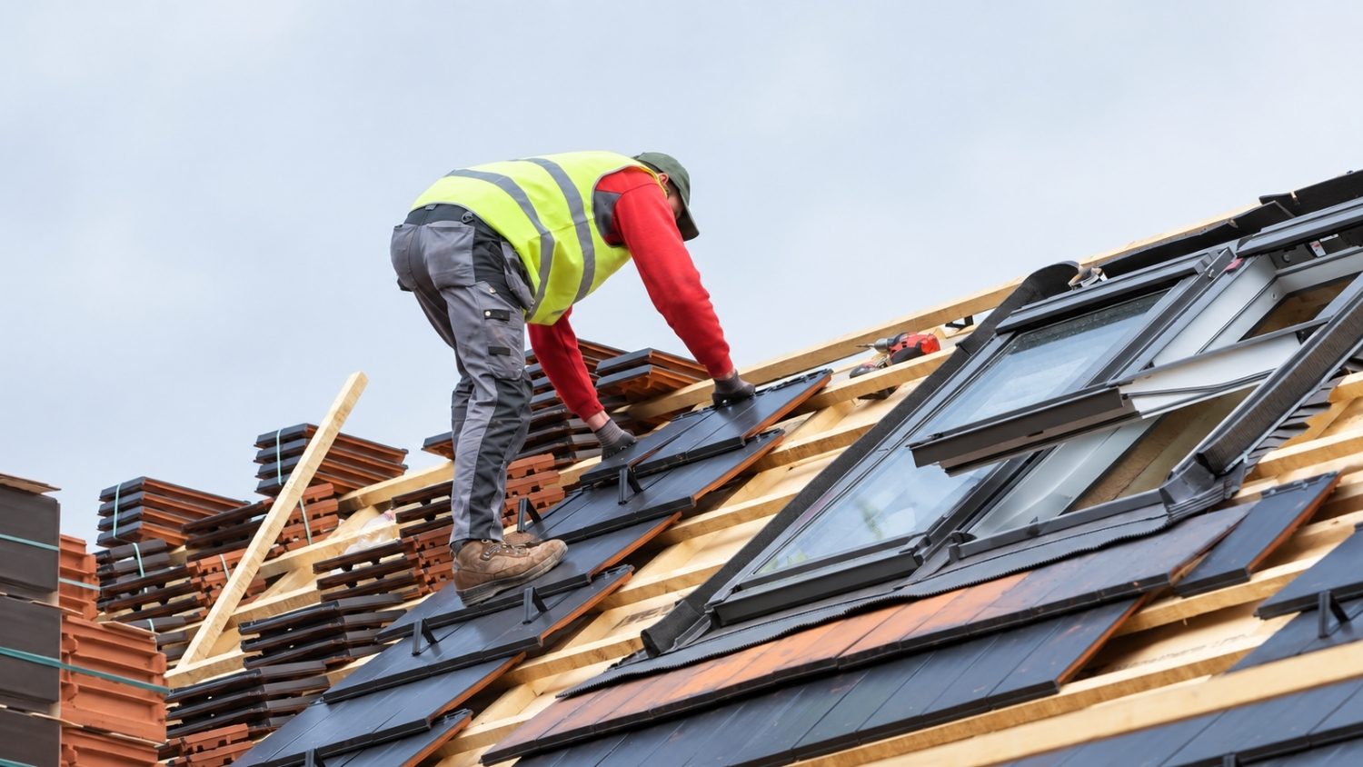 placing roof tile on roof